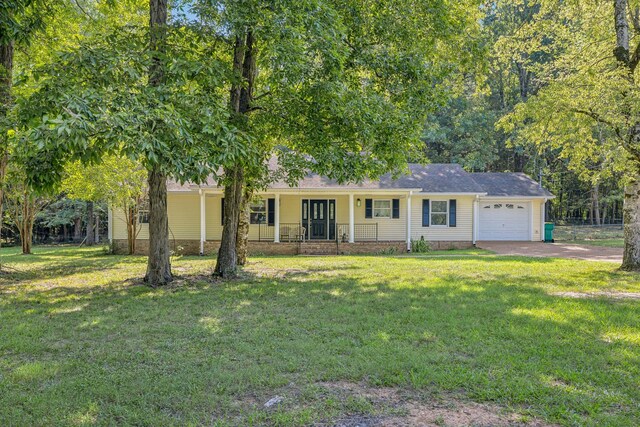 ranch-style house featuring a garage, a front lawn, and covered porch