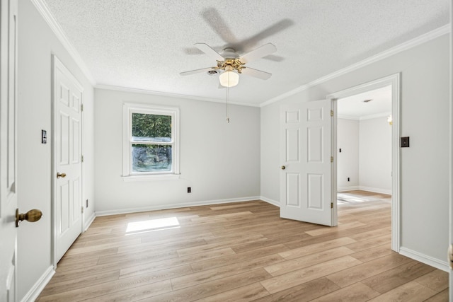 unfurnished bedroom with baseboards, a textured ceiling, light wood-style flooring, and crown molding