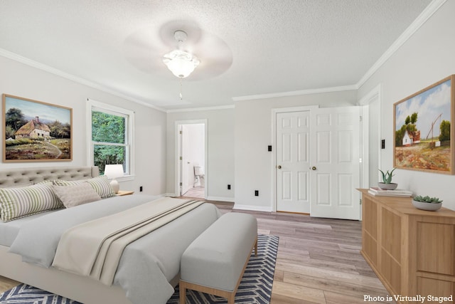 bedroom featuring crown molding, baseboards, light wood-type flooring, and a textured ceiling