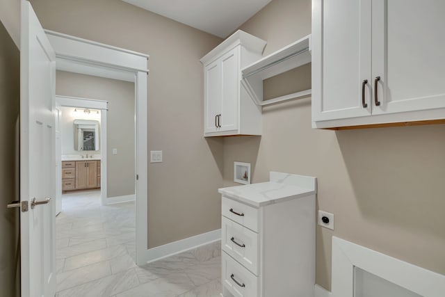 washroom with light tile patterned floors, cabinets, hookup for a washing machine, and electric dryer hookup