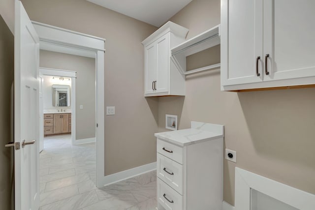 laundry room featuring baseboards, cabinet space, electric dryer hookup, washer hookup, and marble finish floor