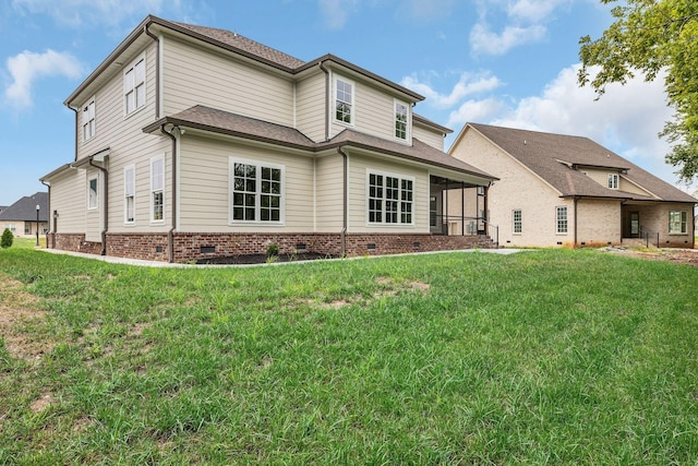 back of property with roof with shingles, a yard, a sunroom, and crawl space