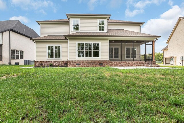 rear view of property featuring a yard