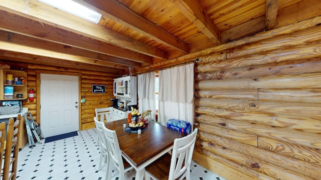 tiled dining room featuring beam ceiling, rustic walls, and wooden ceiling