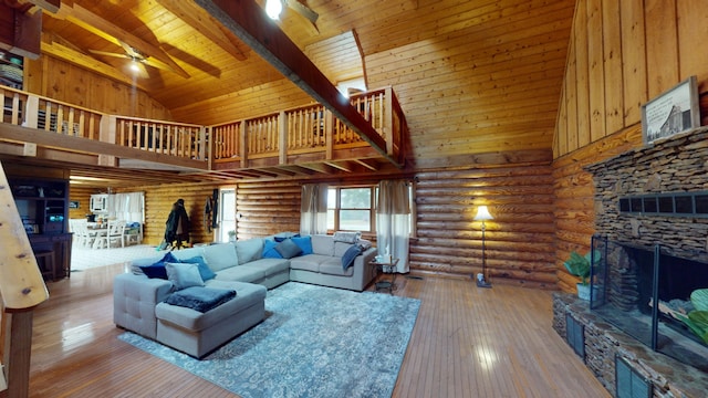 living room featuring high vaulted ceiling, a stone fireplace, hardwood / wood-style flooring, ceiling fan, and wood ceiling