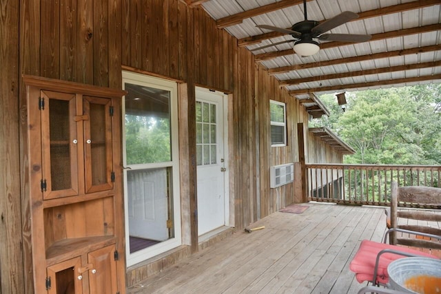 sunroom / solarium featuring vaulted ceiling with beams and a ceiling fan