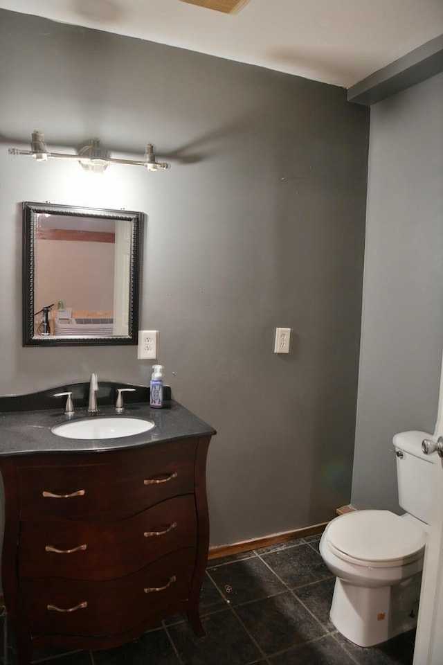 bathroom featuring tile patterned floors, vanity, and toilet