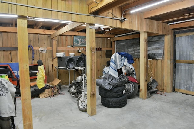 basement featuring wooden walls