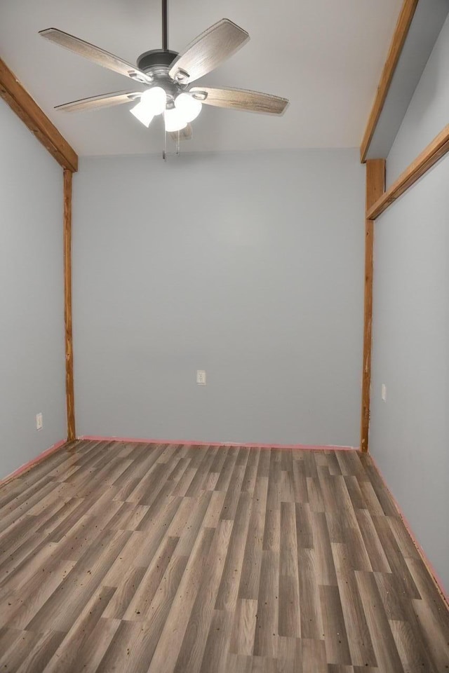 empty room with a ceiling fan and wood finished floors