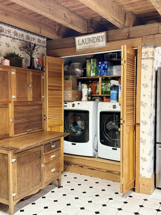 laundry area featuring washing machine and clothes dryer, light tile patterned floors, and wooden ceiling