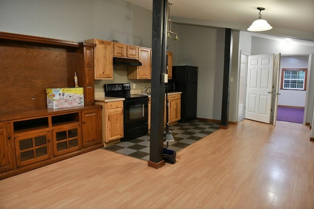 kitchen with lofted ceiling, dark floors, under cabinet range hood, black appliances, and pendant lighting