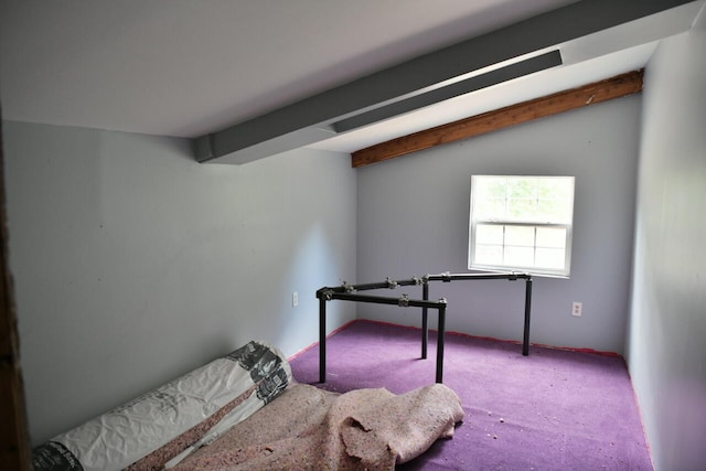 carpeted bedroom featuring lofted ceiling with beams