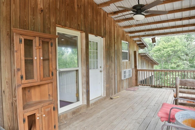 wooden terrace featuring a ceiling fan