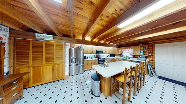 kitchen with light floors, open shelves, light countertops, appliances with stainless steel finishes, and beamed ceiling