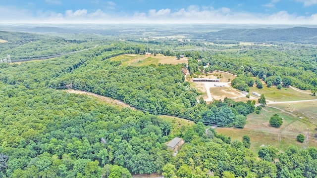 drone / aerial view with a wooded view