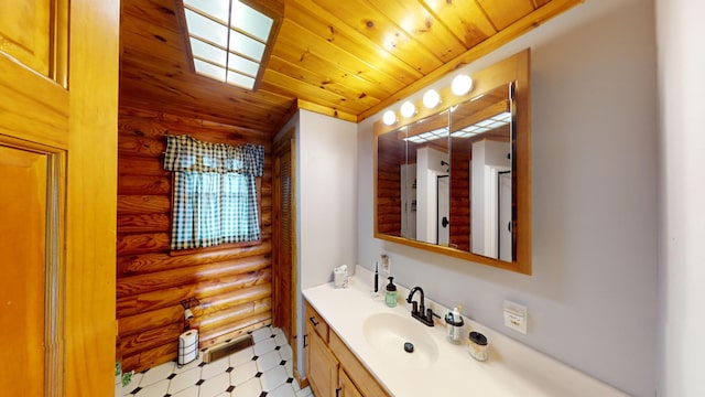 bathroom with wooden ceiling, vanity, and rustic walls