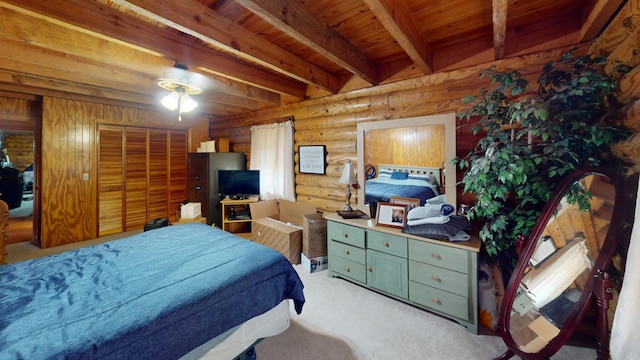 bedroom with beam ceiling, wooden ceiling, rustic walls, a closet, and light colored carpet