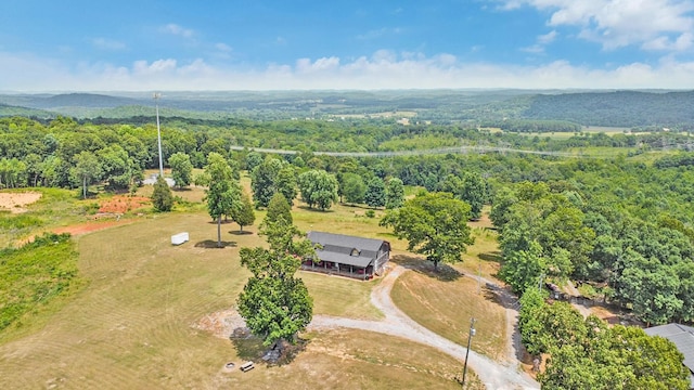 drone / aerial view featuring a forest view