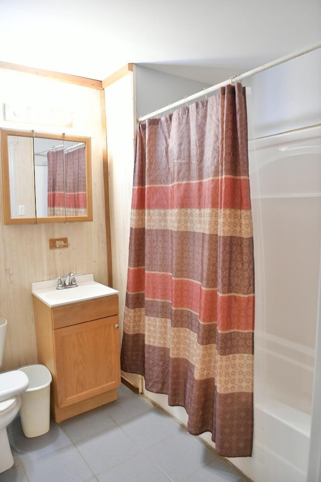 full bathroom with vanity, shower / bathtub combination with curtain, toilet, and tile patterned flooring