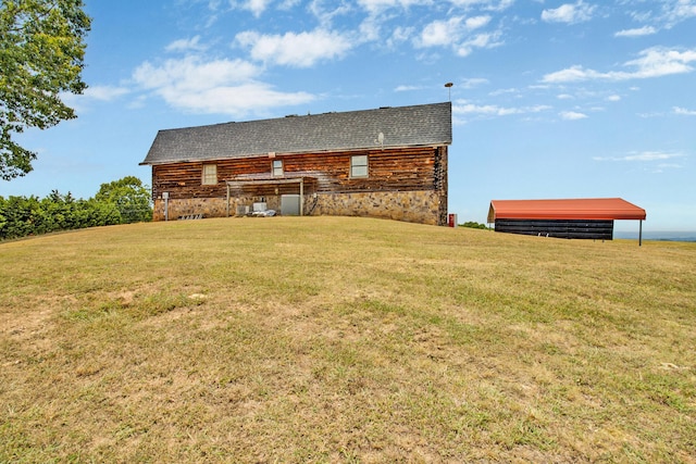 rear view of house featuring a lawn