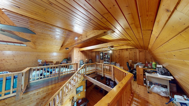 interior space featuring wood walls, light wood-type flooring, wood ceiling, and vaulted ceiling