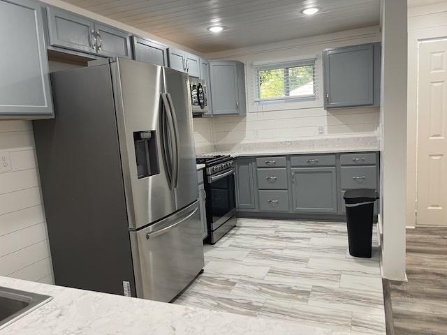 kitchen with backsplash, gray cabinetry, appliances with stainless steel finishes, and wooden ceiling