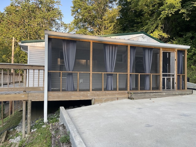 rear view of property with a sunroom