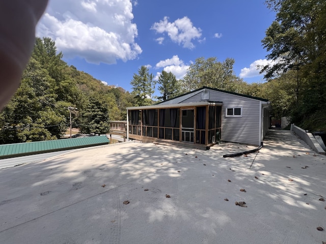 back of property featuring a sunroom