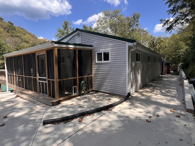 back of property with a sunroom