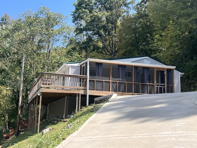 view of front of house featuring a wooden deck and a sunroom