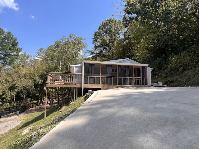 view of front of property with a sunroom and a deck