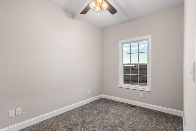 spare room with ceiling fan and carpet