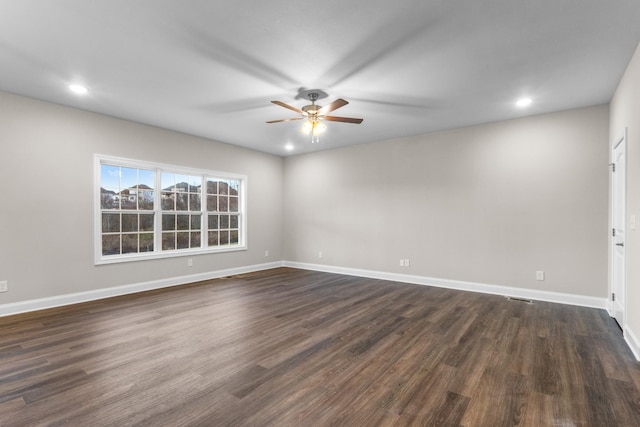 empty room featuring ceiling fan and dark wood-type flooring