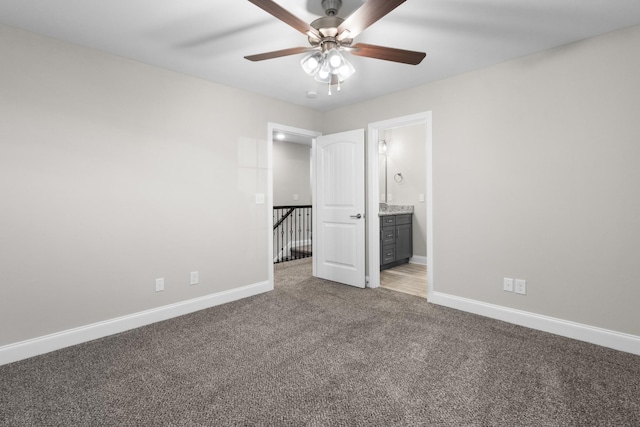 unfurnished bedroom with carpet, ensuite bathroom, and ceiling fan