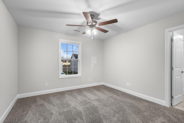 carpeted empty room featuring ceiling fan