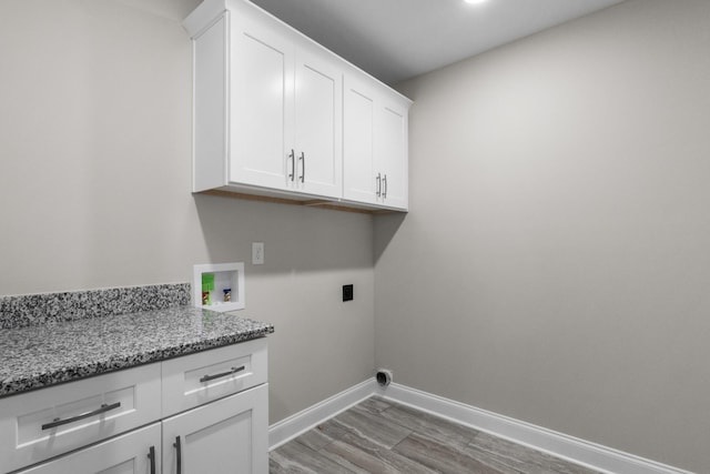 laundry area featuring cabinets, wood-type flooring, hookup for an electric dryer, and washer hookup