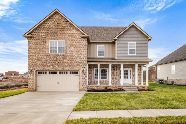 view of front property featuring covered porch, a garage, and a front lawn