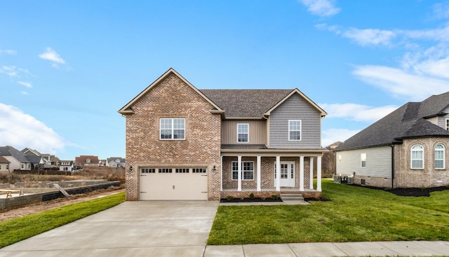 view of front of house with covered porch, a garage, and a front lawn