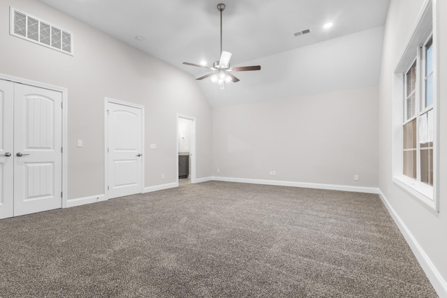 unfurnished bedroom featuring carpet, ceiling fan, and high vaulted ceiling