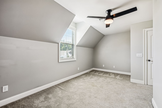 additional living space with lofted ceiling, light carpet, and ceiling fan