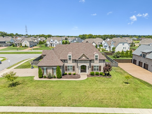 french country inspired facade with a front yard