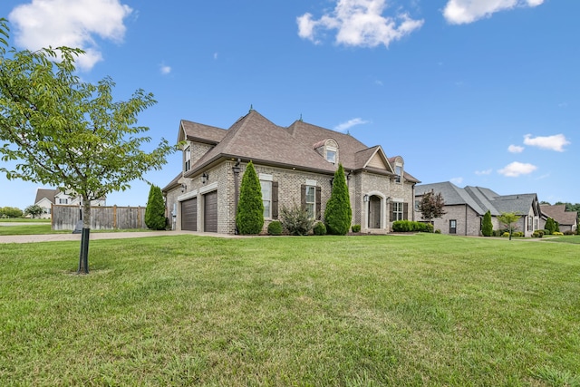 view of front of house featuring a garage and a front yard