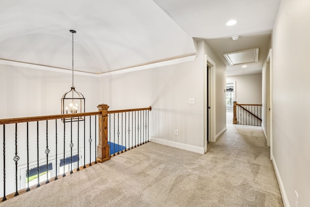 corridor featuring a chandelier and carpet floors