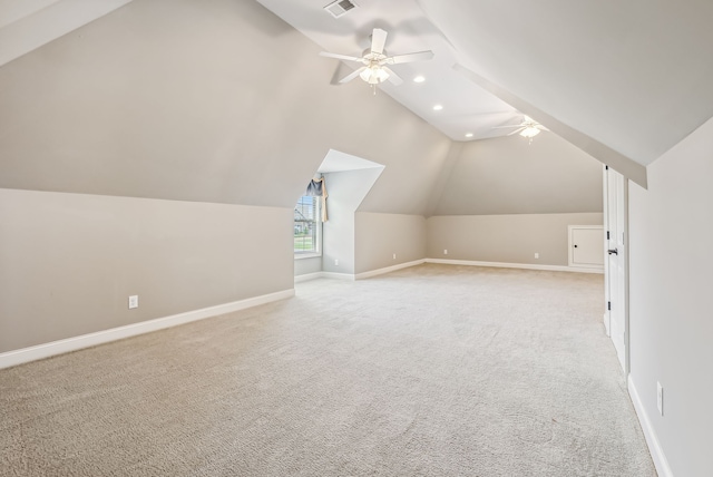 additional living space featuring ceiling fan, lofted ceiling, and light carpet