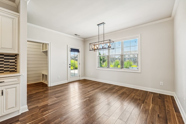 unfurnished dining area featuring a wealth of natural light, dark wood-type flooring, and ornamental molding