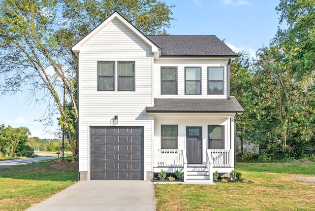 view of front of home with a front lawn, a garage, and covered porch