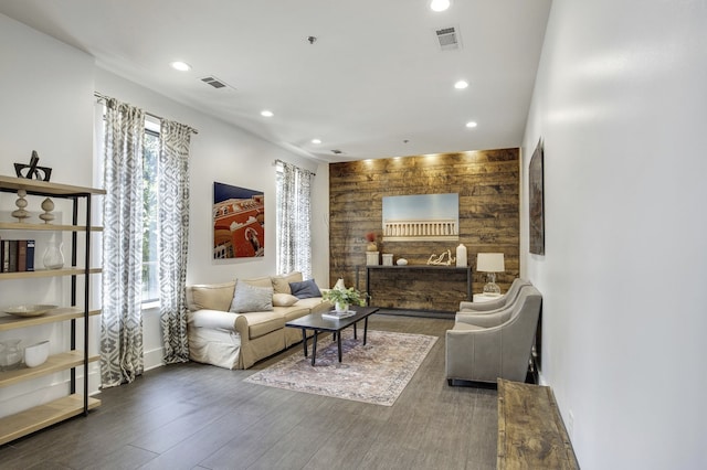 living room featuring wood-type flooring and wood walls