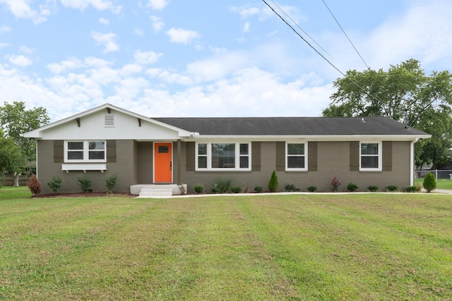 ranch-style house featuring a front yard and brick siding