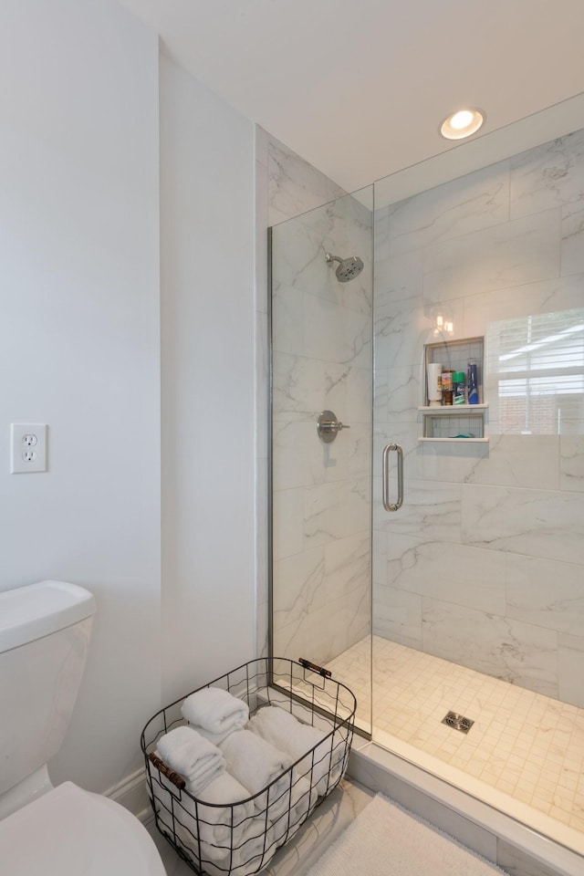 bathroom with recessed lighting, a stall shower, and toilet