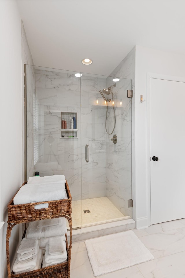 bathroom with a marble finish shower, recessed lighting, and marble finish floor